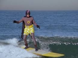 batman surfing off shore..